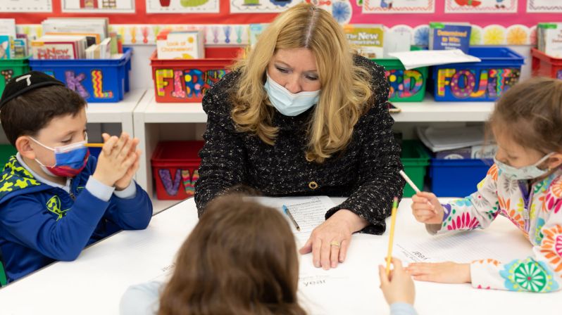 Teacher working with students.